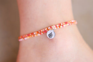 Hand stamped hibiscus seed beaded charm anklet